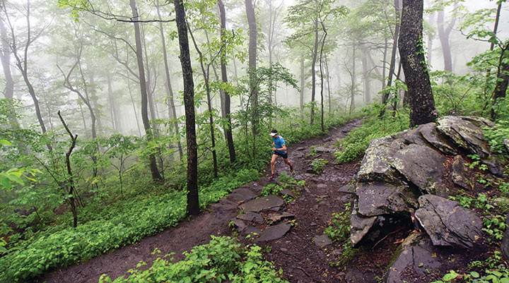 Scott Jurek running on a muddy section of the Appalachian Trail